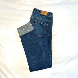 Cuffed jeans with pearl embellishments